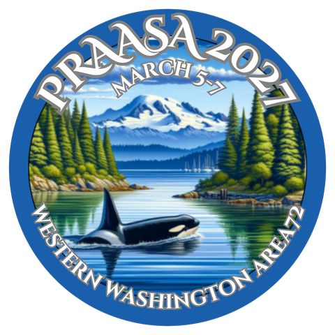 The PRAASA 2027 logo: an orca surfacing in a calm inlet lined with evergreens, below a snow-capped mountain.